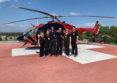 Residents standing in front of the CCMH Helicopter